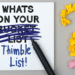 Notepad with What's on your bucket list, but bucket list is crossed out and Thimble List! is added. Yellow question mark to the right of the pen.
