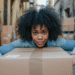 Woman with big box in hand, surrounded by other boxes
