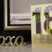 18th birthday card, gold outline on frireplace mantel next to XOXO brass decor piece