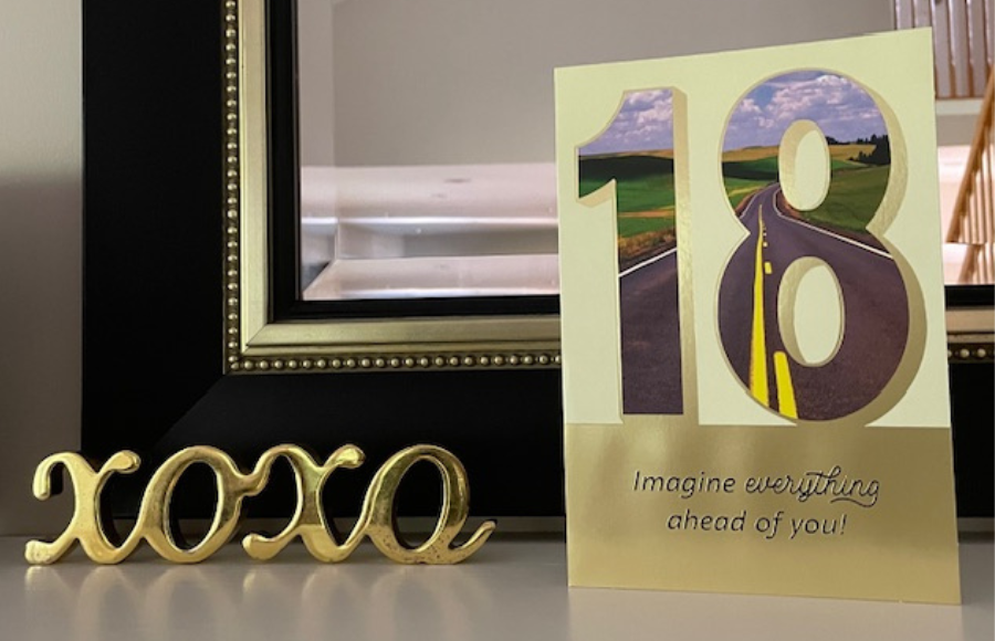 18th birthday card, gold outline on frireplace mantel next to XOXO brass decor piece