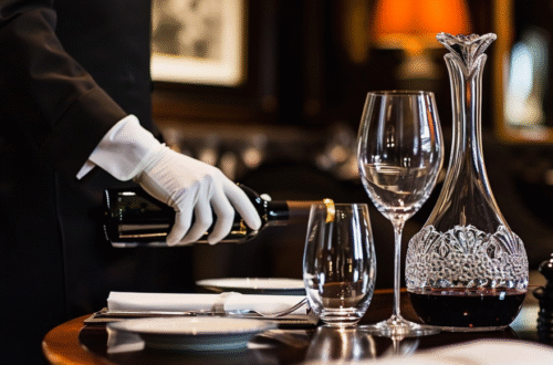 butler's arm pouring wine very fancy