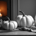 white pumpkins in front of a fireplace