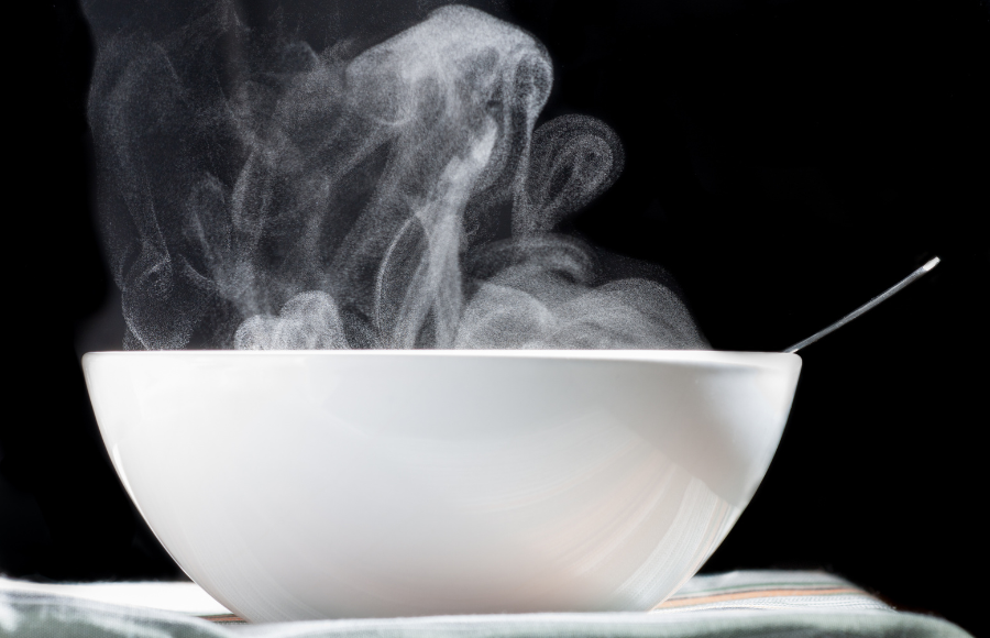 White bowl of hot food in black and white print