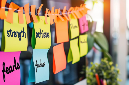 A string of post it notes, like on a makeshift washing line but in an office.