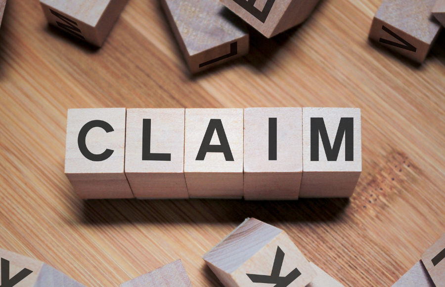 CLAIM spelled out in cube pieces like scrabble