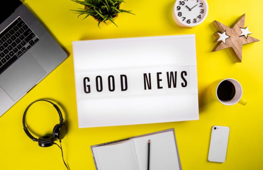 Good News sign on neon yellow table