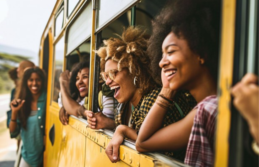 Beautiful black women traveling on a yellow bus in the tropics