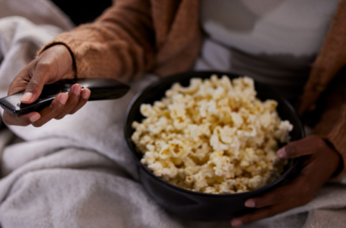 CLose up of a popcorn on woman's lap