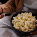 CLose up of a popcorn on woman's lap