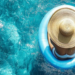 Woman with large hat covering most of her body, in a crystal clear body of water