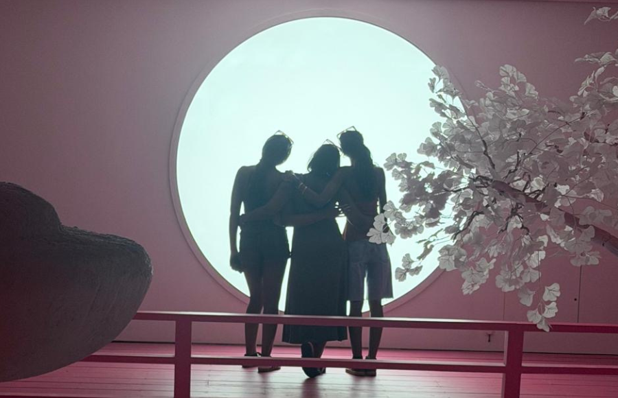 Photo - IreneB in the middle of my two beautiful girls, back to camera, facing a moon art installation in a pink room - Moco museum.