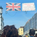 Photo - back of IreneB kids and fam walking under the Portobello Road banner with two Union Jack flags.